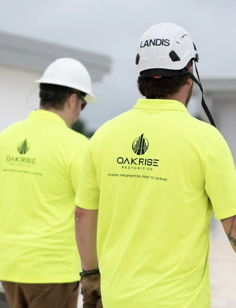 Workers cleaning construction debris from TPO Membrane Roof with professional surface washer and detergent