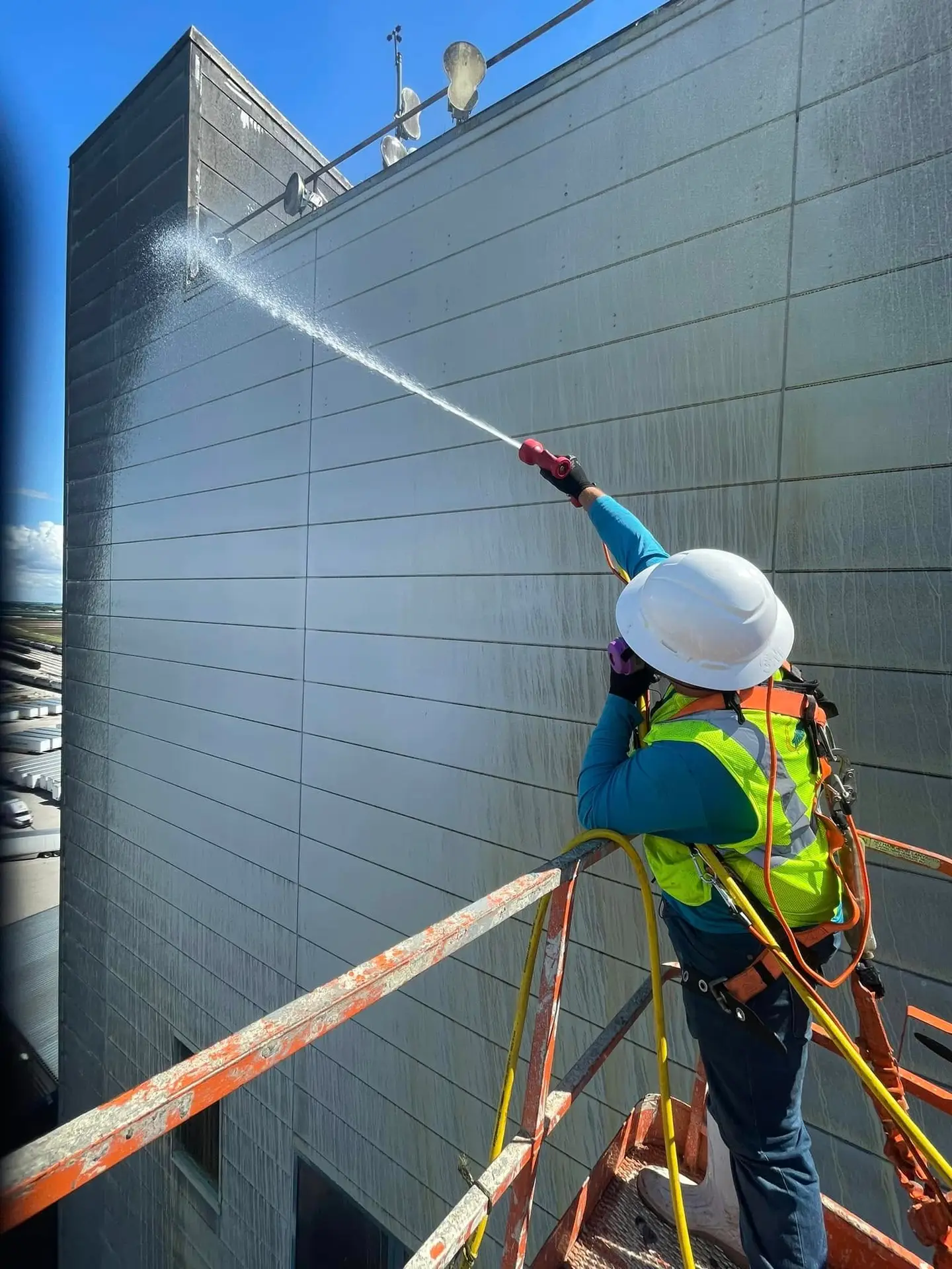 technician restoring oxidized metal building panels