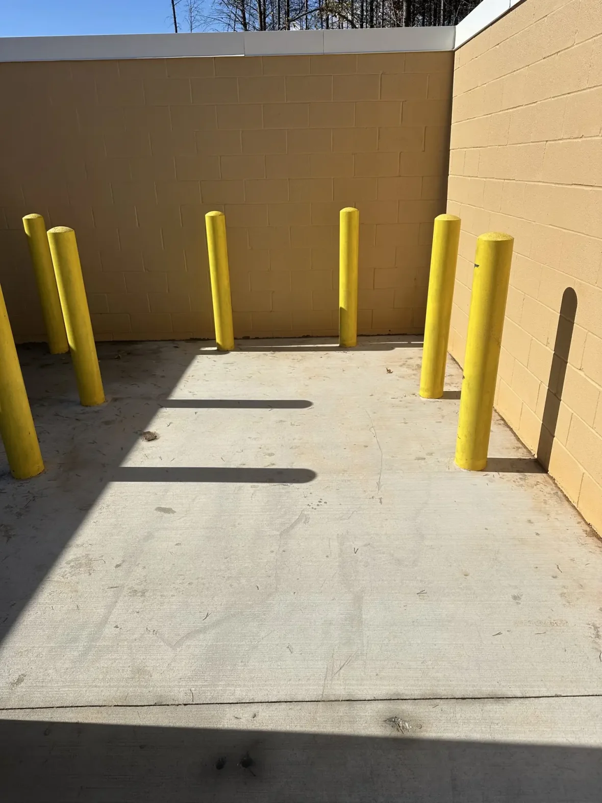 Clean commercial dumpster pad after pressure washing
