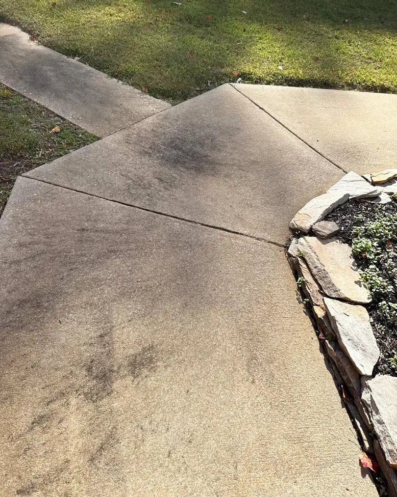 Stained concrete sidewalk before pressure washing