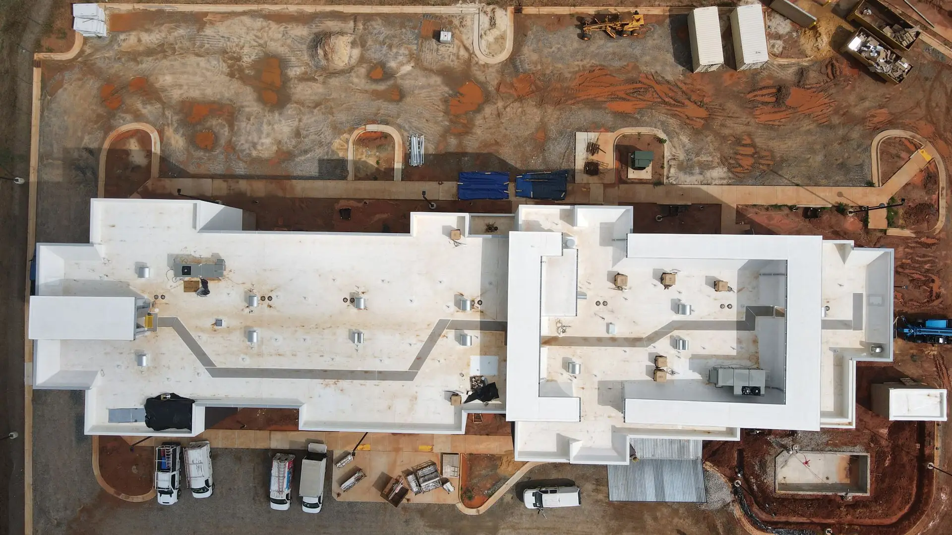 Aerial view of commercial flat TPO roof before cleaning
