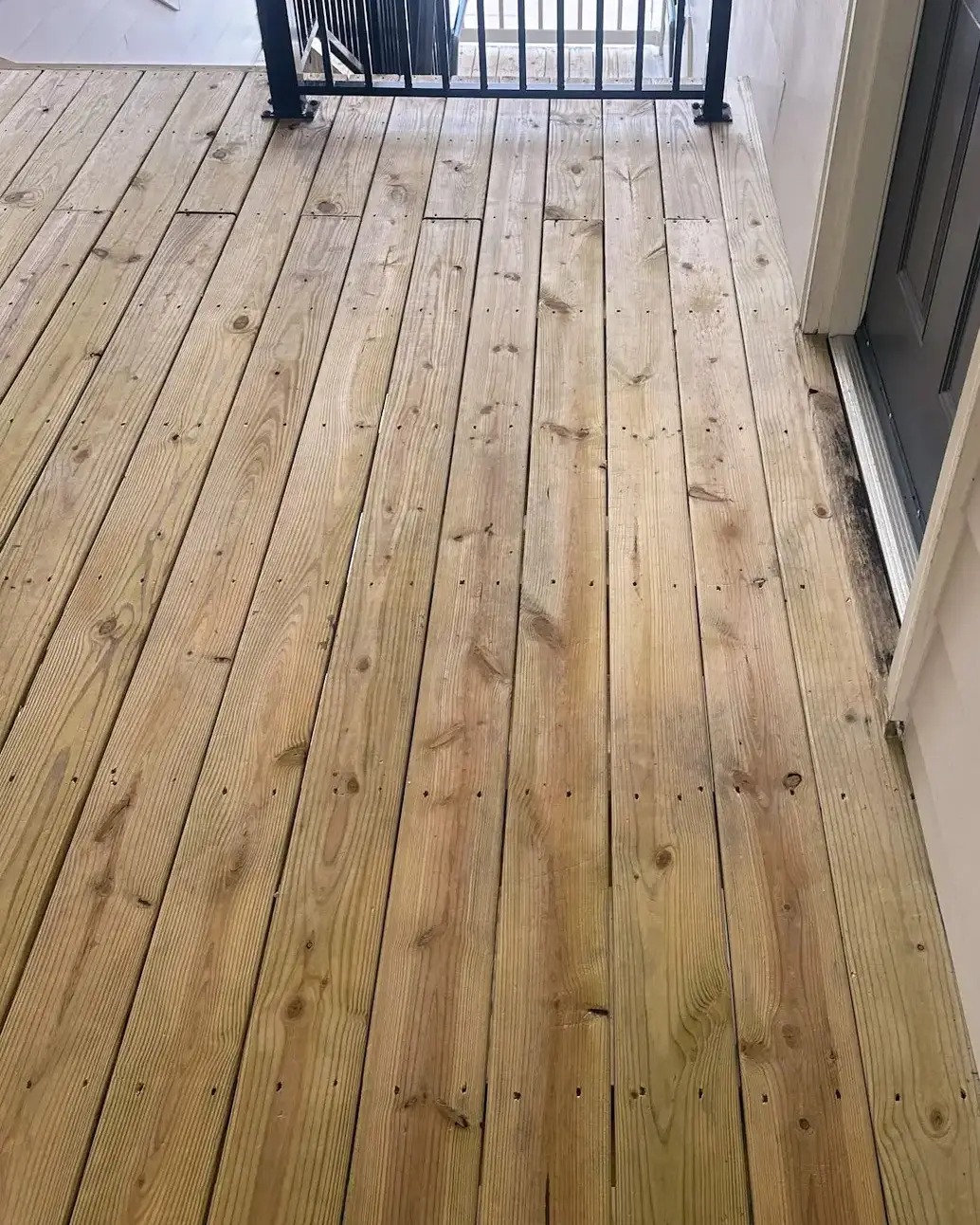 Wood apartment breezeway after exterior surface cleaning