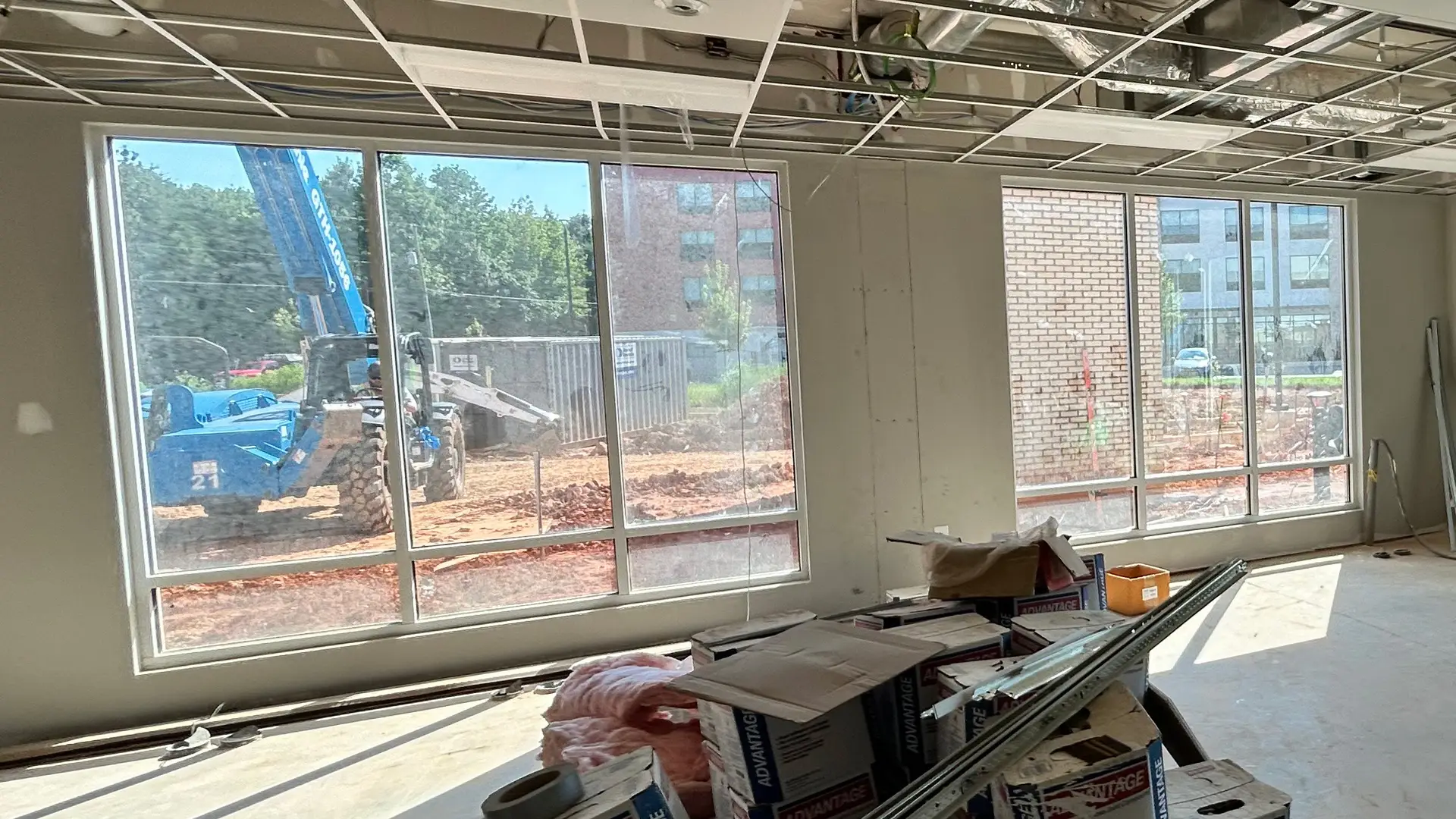 Hotel lobby windows with construction dust before professional glass cleaning