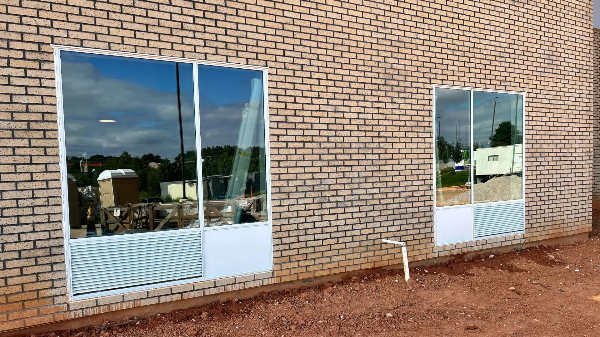 Clean commercial windows with detailed frames and louvers